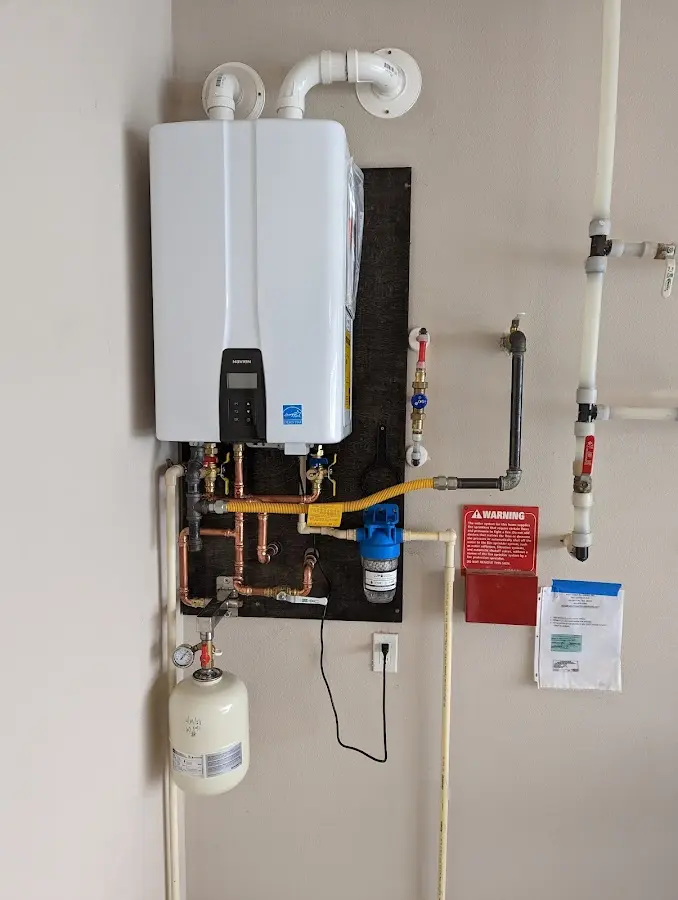 Professional plumber installing copper piping in a Taymouth home